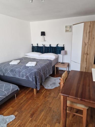 a bedroom with two beds and a table at Dom Jastarnia Apartamenty in Jastarnia