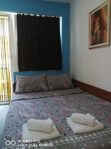 a bedroom with a bed with two towels on it at Villa Ohrid Anastasia in Ohrid