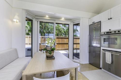 a living room with a table and a couch at Hale Nanea home in Kilauea
