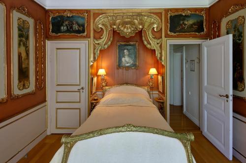 a bedroom with a bed in a room with orange walls at Mauritzbergs Slott & Golf in Mauritsberg