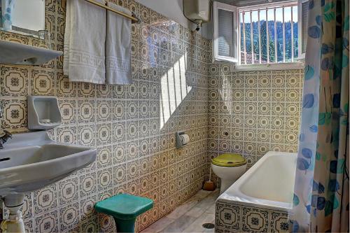baño con lavabo y aseo y ventana en Hotel Benitses Arches, en Benitses