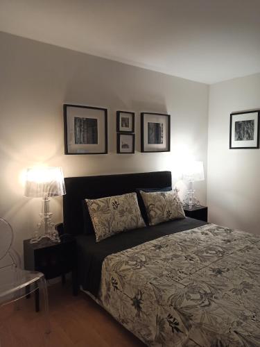 a bedroom with a bed with three pictures on the wall at villa josepha in Cournon-dʼAuvergne