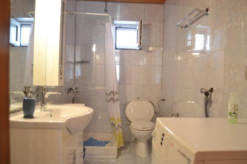 a bathroom with a sink and a toilet and a shower at Lazatka flat in capital Chora in Samothráki