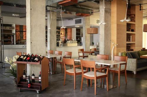 a restaurant with tables and chairs and bottles of wine at Design Studio in Atlantis Resort&SPA, Burgas Airport in Burgas City