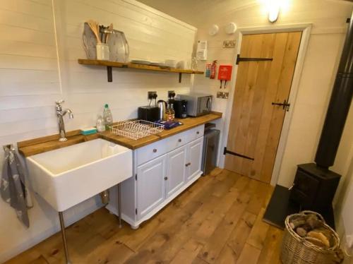 a kitchen with a sink and a counter top at Plum Hut in Torquay