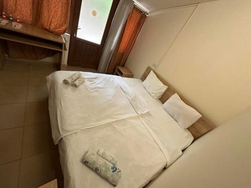 a small bedroom with a bed with white sheets and pillows at Popock City Center in Yerevan