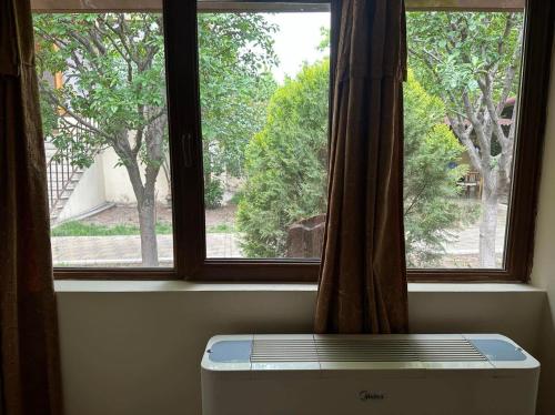 a window with a view of a tree at Popock City Center in Yerevan