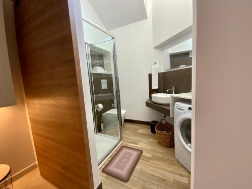 a bathroom with a sink and a washing machine at “Bedda Mattri” dimora siciliana in Avola