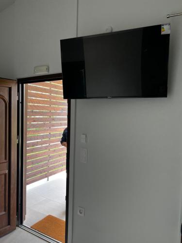 a flat screen tv on top of a wall at Naiades Villas Aigli in Ladharió