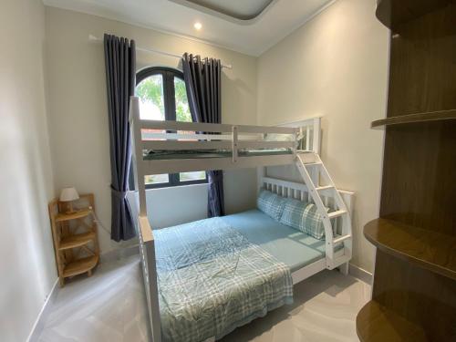 a bedroom with a bunk bed and a ladder at Le Villa Ke Ga Lighthouse in Ke Ga