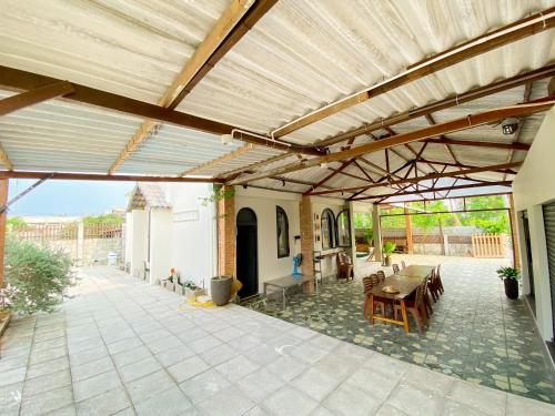 an outdoor patio with a wooden pergola at Le Villa Ke Ga Lighthouse in Ke Ga