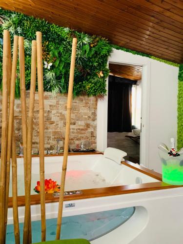 a room with a bath tub with wooden sticks at Suite i biddizzi da Sicilia in Catania