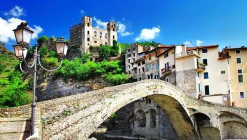 a bridge over a river in a city with buildings at Casa Eva in Dolceacqua
