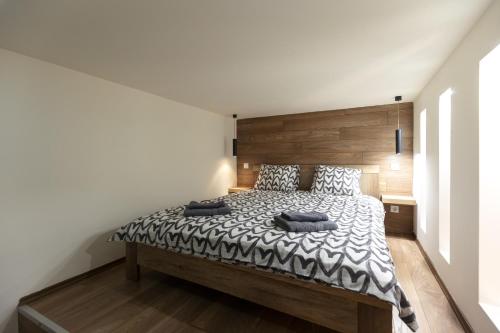 Schlafzimmer mit einem großen Bett mit einem Kopfteil aus Holz in der Unterkunft Kazinczy 10 Apartment with 3 bedrooms in Budapest
