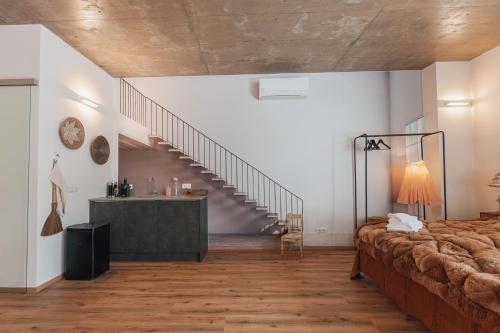 a large room with a bed and a staircase at MischMasch Appartement in Deutschlandsberg