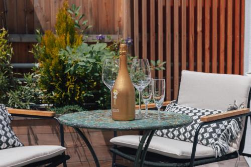 a bottle of champagne sitting on a table with wine glasses at MischMasch Appartement in Deutschlandsberg