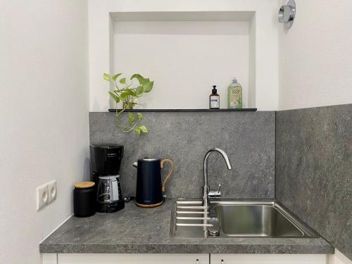 a kitchen counter with a sink and a mirror at City Apartment in Bornheim - Köln Bonn Phantasialand in Bornheim