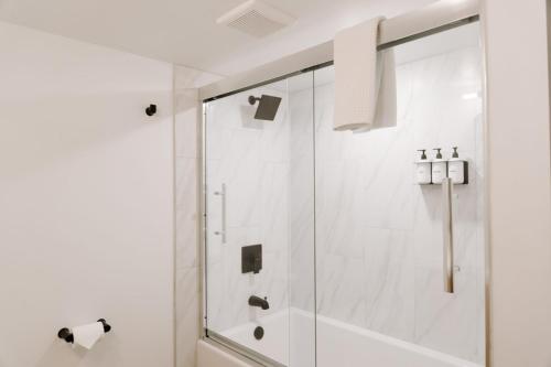 a shower with a glass door in a bathroom at Nature Link Resorts in Nisswa