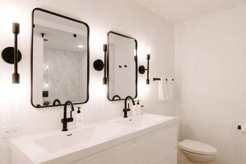 a bathroom with a sink and two mirrors at Nature Link Resorts in Nisswa