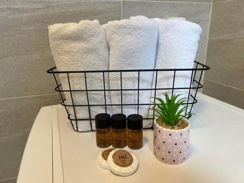 a basket of towels and a plant on a counter at Gargovic Apartments in Budva