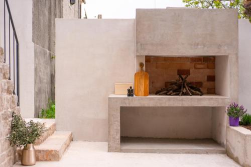 a concrete fireplace in a courtyard of a house at She House - built for pleasure - Island of Brač in Gornji Humac