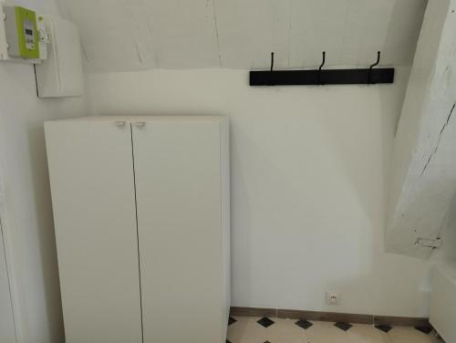 a kitchen with a white refrigerator in a room at Studio Cosy en centre ville in Arpajon