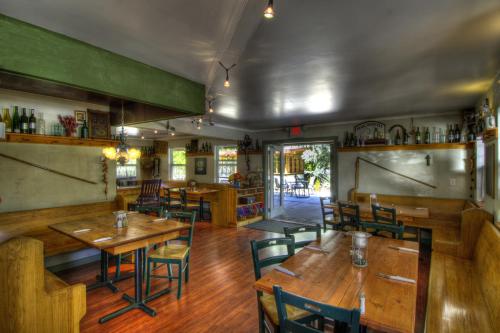 an empty restaurant with wooden tables and chairs at Crowsnest Vineyards Guesthouse in Keremeos