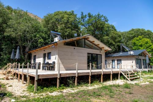 a small house with a porch and a deck at Ecopark Tuzlata Екопарк Тузлата in Balchik