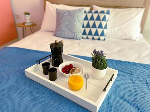 a tray with a breakfast on a bed at Down town villa Kavala in Kavála