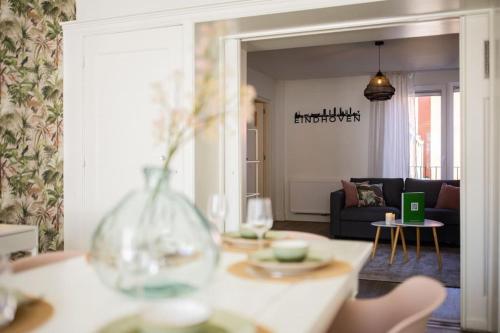 a living room with a couch and a table with wine glasses at Elegant 2 Bedroom Apartment 75m2 - SD23G in Eindhoven