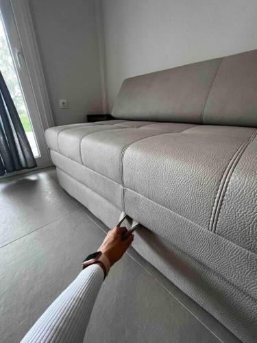 a person is cutting into a bed in a room at •Naiades Villas• Odysseus• in Ladharió