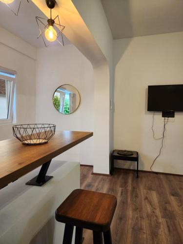 a living room with a table and a tv at Apartmani Radman in Igalo