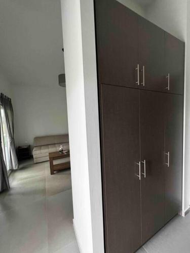 a living room with a large cabinet and a couch at •Naiades Villas• Odysseus• in Ladharió