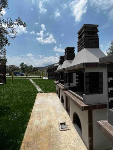 a building with a pathway leading to a grass field at •Naiades Villas• Odysseus• in Ladharió