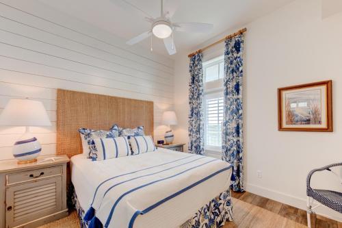 a bedroom with a bed and a ceiling fan at Blowfish Bungalow Rooftop Balcony, Boardwalk to Beach in Port Aransas