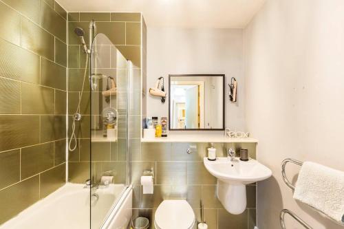 a bathroom with a shower toilet and a sink at Mosh Homes 01 in Manchester