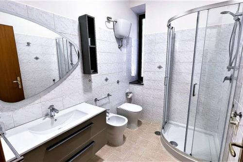a bathroom with a shower and a sink and a toilet at Il Giardino degli aranci in Pisciotta