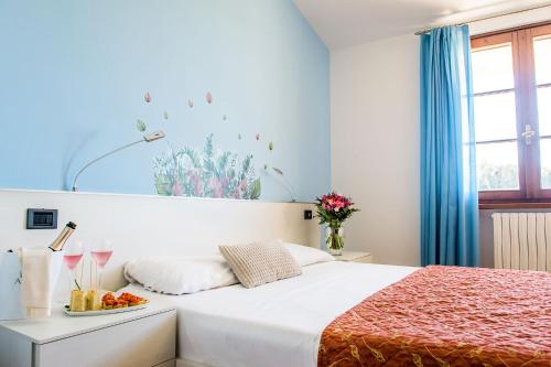 a bedroom with a bed with a plate of fruit on it at Hotel Il Castello in Pozzolengo