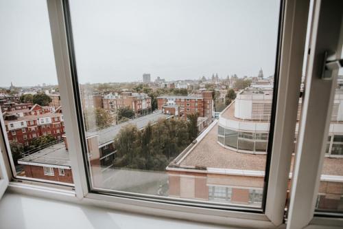 a view of a city from a window at Penthouse at Chelsea Cloisters Hotel in London