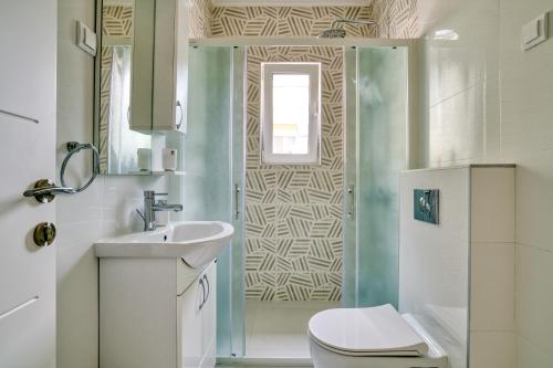 a bathroom with a toilet and a sink and a shower at The Golden Luxury Apartments in Kotor