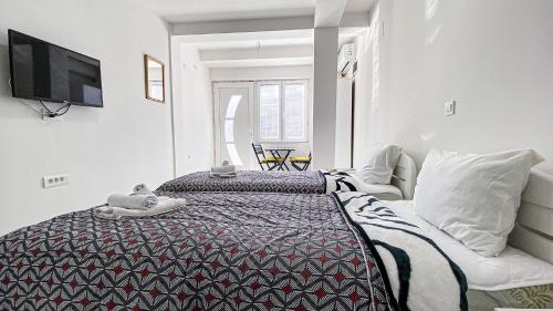a hotel room with a bed and a tv at Vila Shogun in Ohrid