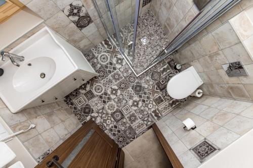 an overhead view of a bathroom with a sink and shower at Atpūtys in Palanga