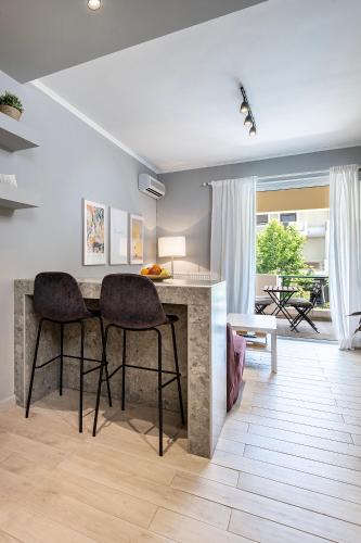 a living room with a table and two chairs at Warmth & Charm Island Style in Kos Town