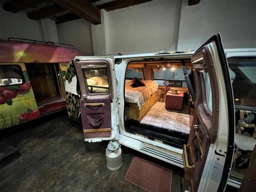 a van with its door open in a room at Urban Van Glamping Riga in Rīga