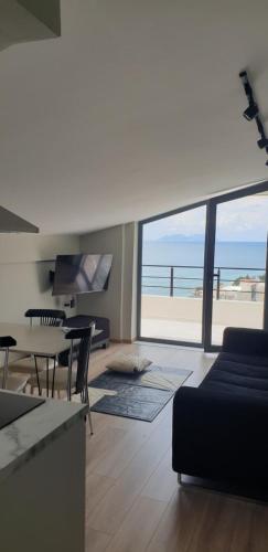 a living room with a view of the ocean at Rezidenca Oliva in Vlorë