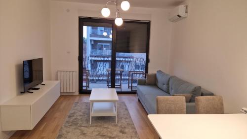 a living room with a couch and a table at Apartment DT48 in Pančevo