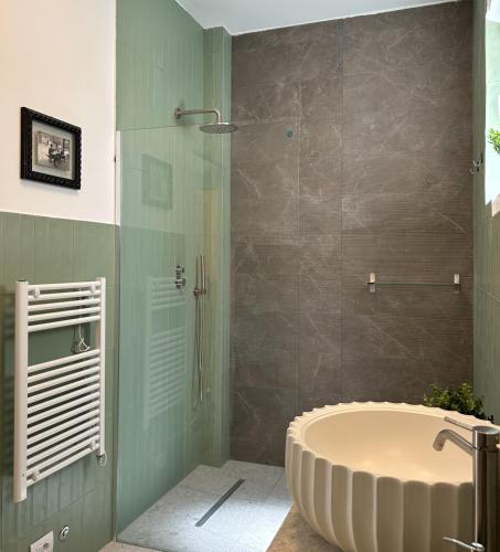 a bathroom with a large tub and a shower at Caves Garden in Bari