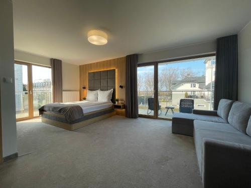 a bedroom with a bed and a couch at Sea Resort 1 & Spa in Władysławowo