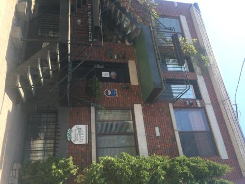 a tall brick building with a fire escape at Maison Des Jardins B & B in Montréal
