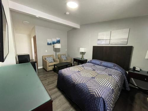Golden Kent Motel في كينت: غرفة نوم مع سرير وغرفة معيشة